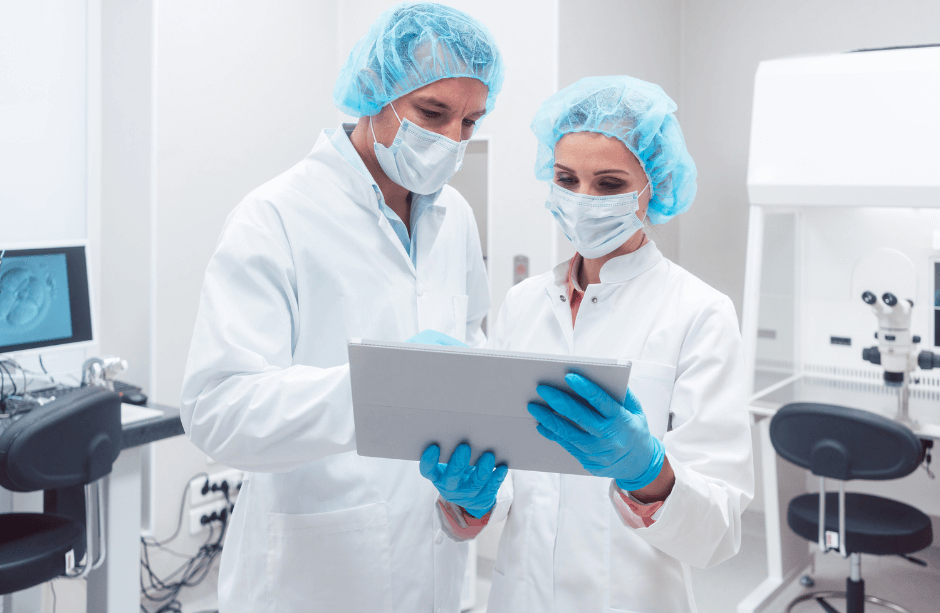 Two medical experts looking at a tablet