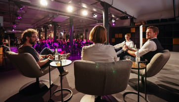 Four people sitting on stage discussing a topic