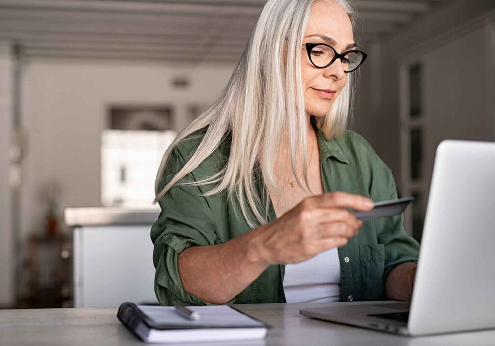 Woman purchasing online using a laptop