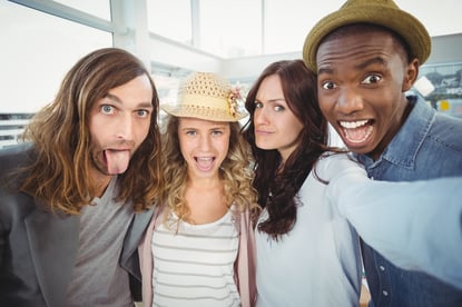 Business team making face while taking self portrait at office