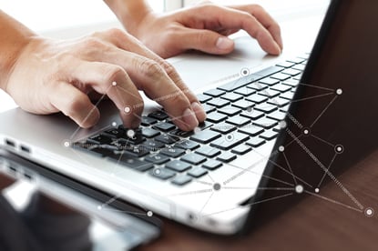 Close up of business man hand working on laptop computer with social network diagram on wooden desk as concept-1