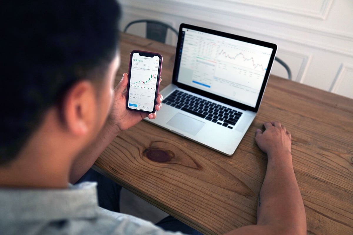 Man holding a phone using a banking app