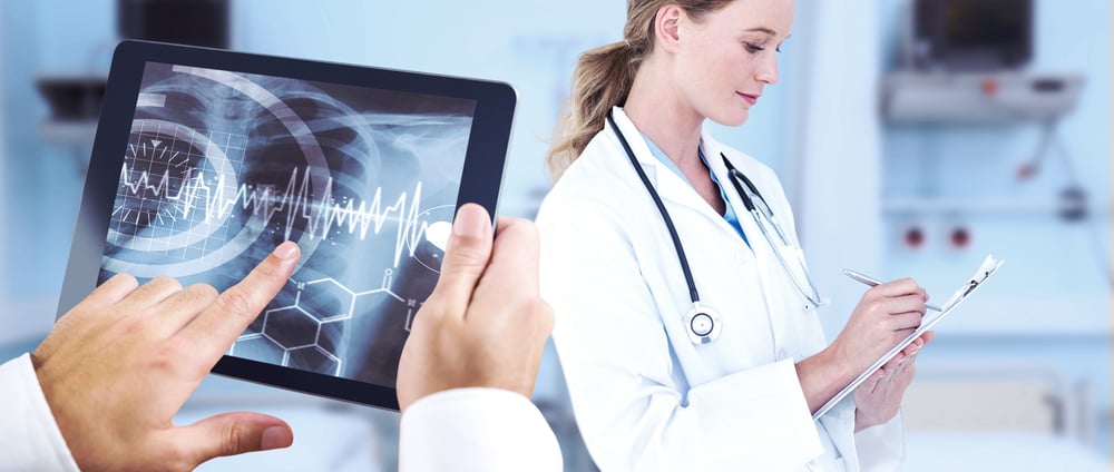 Man using tablet pc against sterile bedroom.