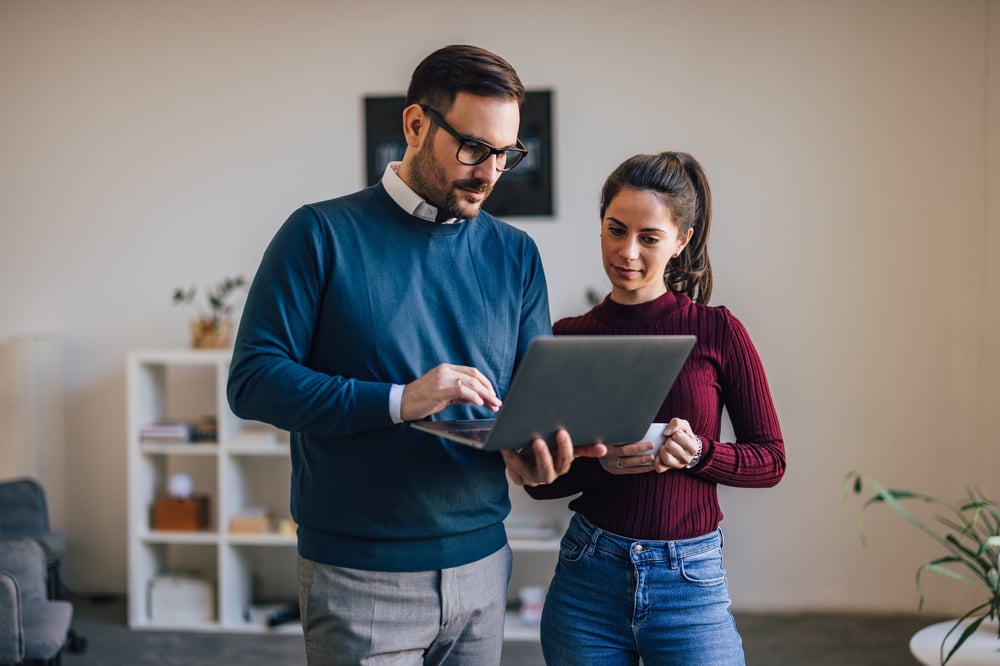 Couple looking at tablet in a cozy apartment.