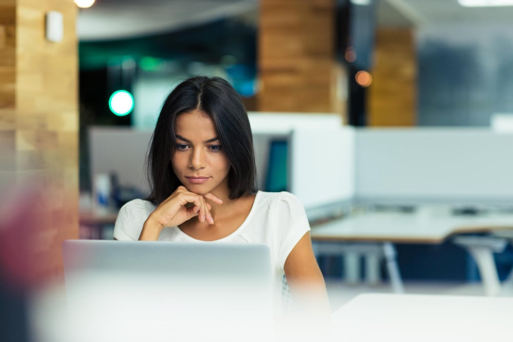 Portrait of a serious businesswoman using laptop in office-2