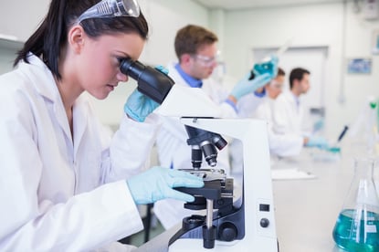 Side view of busy group of researchers working on experiments in the laboratory-2