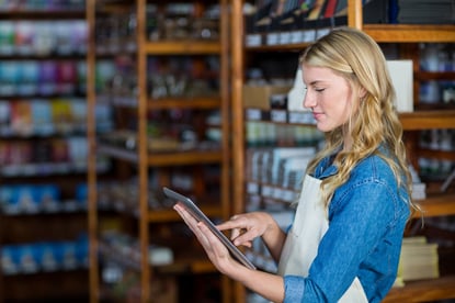 Smiling female staff using digital tablet in supermarket-4