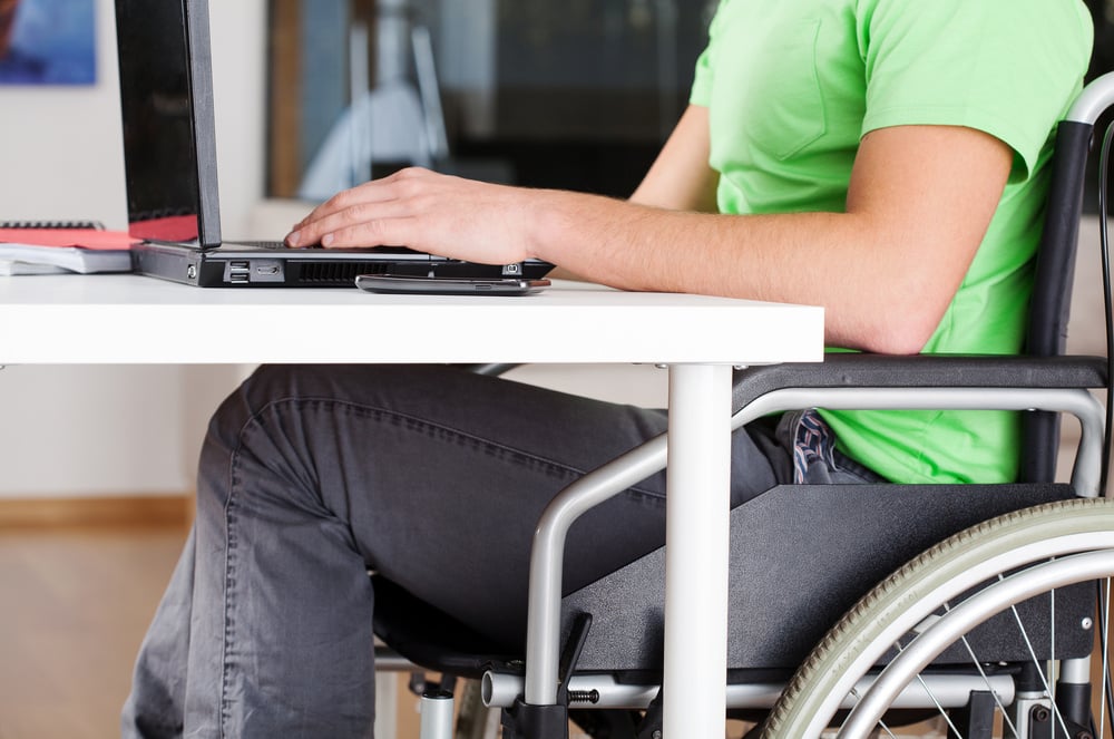 Young man on wheelchair studying in his room-1