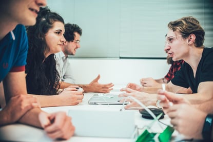 people sitting at the table discussing a new project