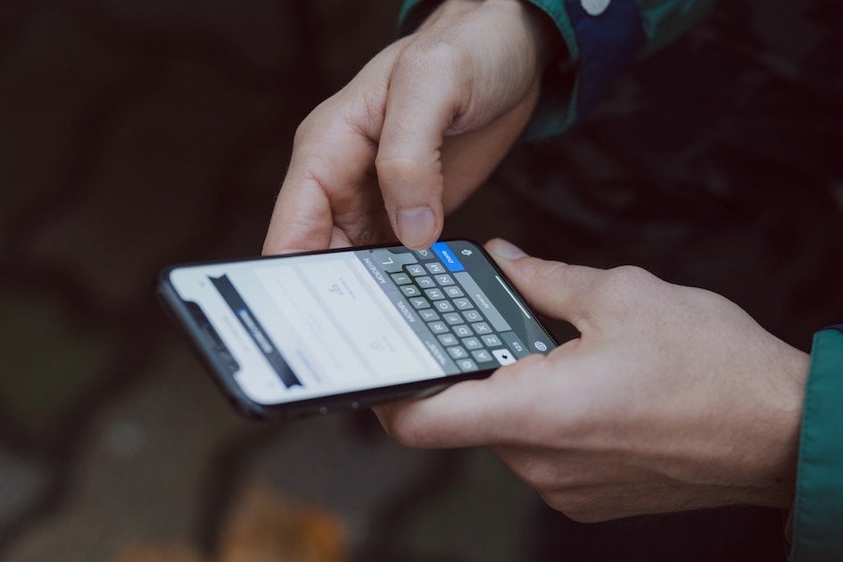 user typing on phone keyboard