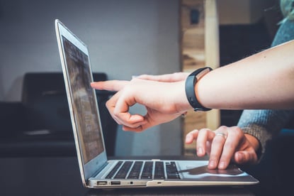 People pointing fingers at a computer