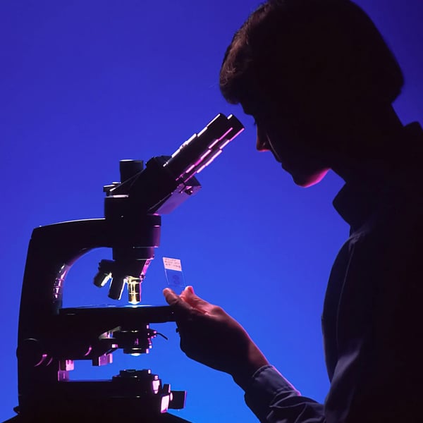 Woman by a microscope.