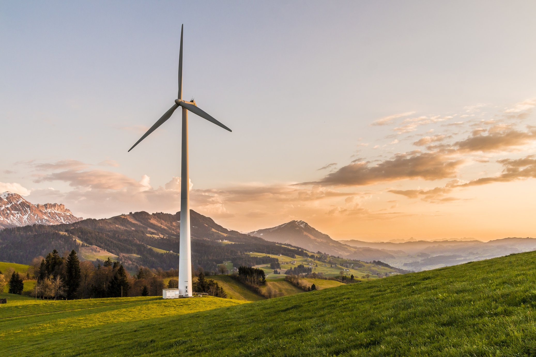 Wind power station in the mountains at sunset.